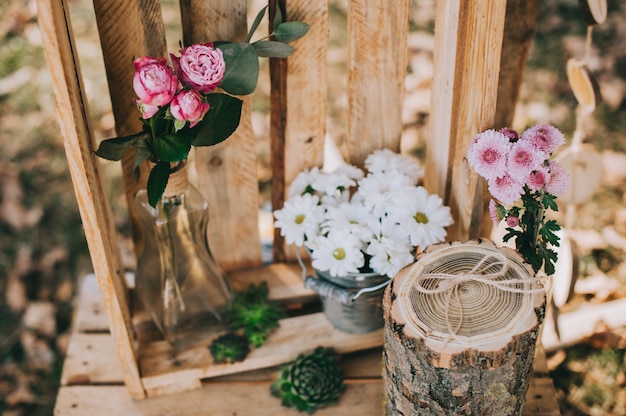 arch for the wedding ceremony of burlap and wooden logs in pine forest