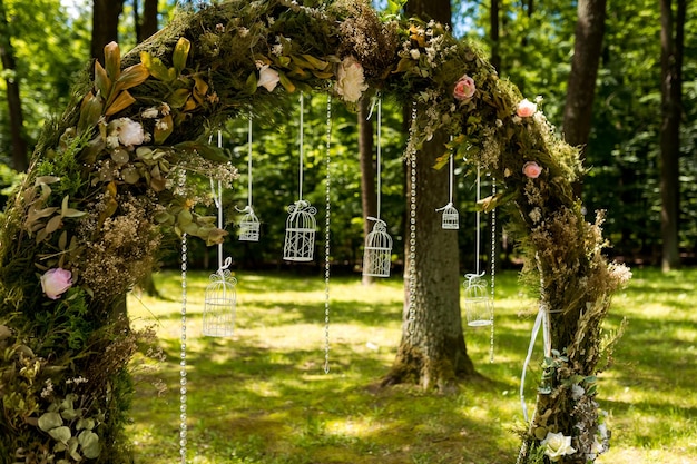 Arch for the wedding ceremony Decorated with flowers and greenery Is located in a pine forest Just married