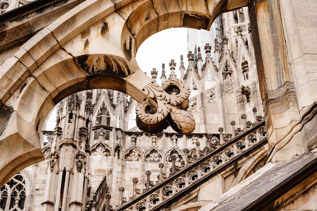 Arch with patterns on the roof of the duomo italy milan