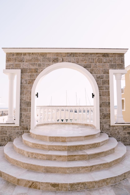 Arched balcony with balustrade and steps overlooking the lustica bay montenegro