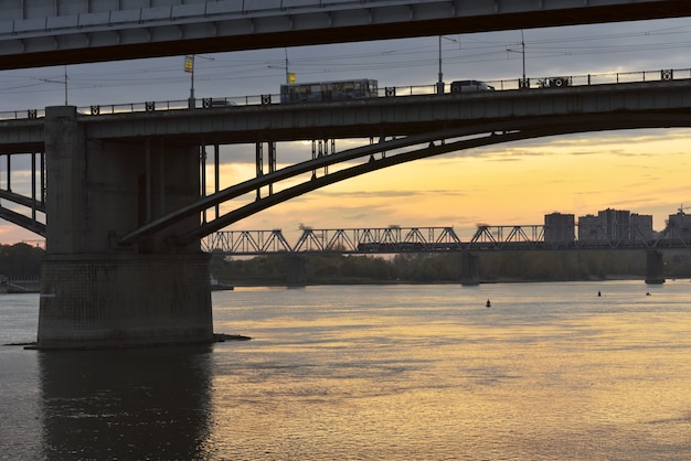 arched road bridge railway bridge over the ob river in the capital of siberia