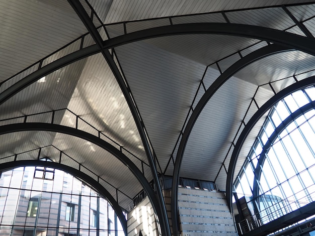 Arches and arches of the station Metal structures under the roof of a large building Construction