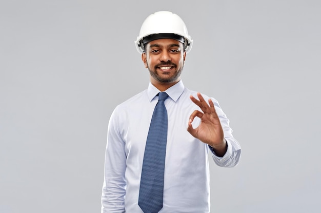 architect or businessman in helmet showing ok