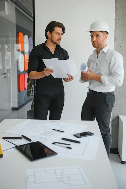 Architect concept Architects working with blueprints in the office