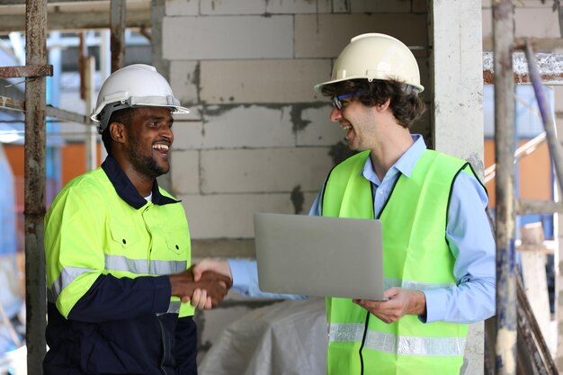 Architect and construction engineer or surveyor discussion plans and blueprints