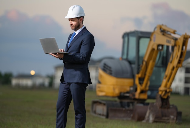 Architect at a construction site Architect man in helmet and suit at modern home building