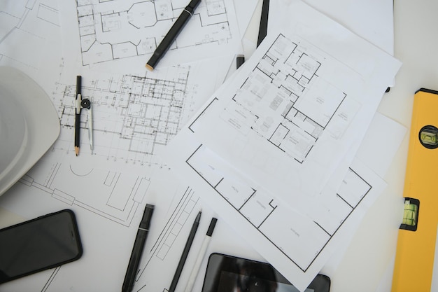 Architect design working drawing sketch plans blueprints and
making architectural construction model in architect studioflat
lay