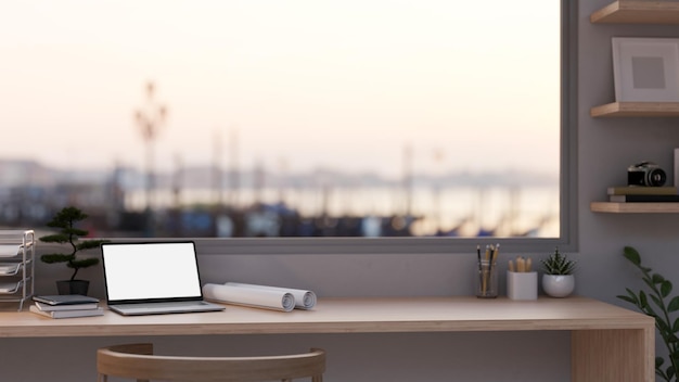 Architect and engineer desk with laptop blueprints and office supplies on table against window