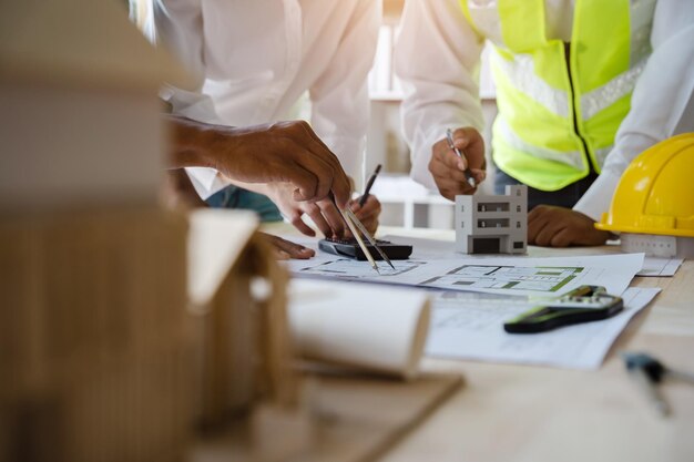 Photo architect or engineer team working on table use drawing tool on the paper plan for business architectural project