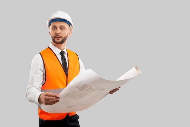 Architect in reflective vest holding construction plan