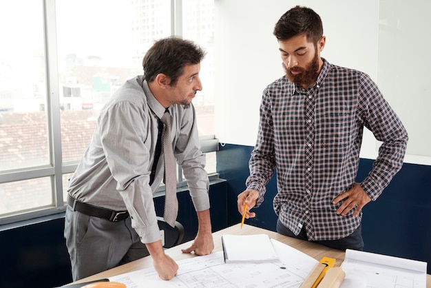 Architect sharing ideas with coworker