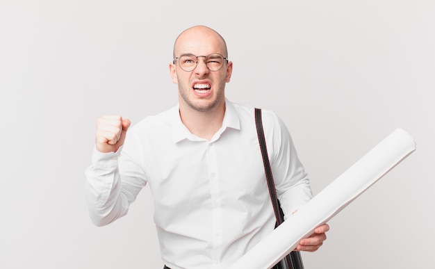 Architect shouting aggressively with an angry expression or with fists clenched celebrating success