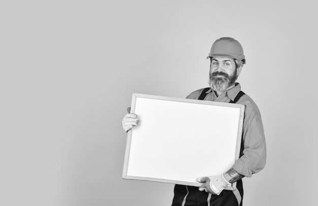 Architect showing project Professional repairman Troubleshoot concept Repairman hold whiteboard copy space Handsome repairman Bearded man repairman builder Plan repair works Visual outline