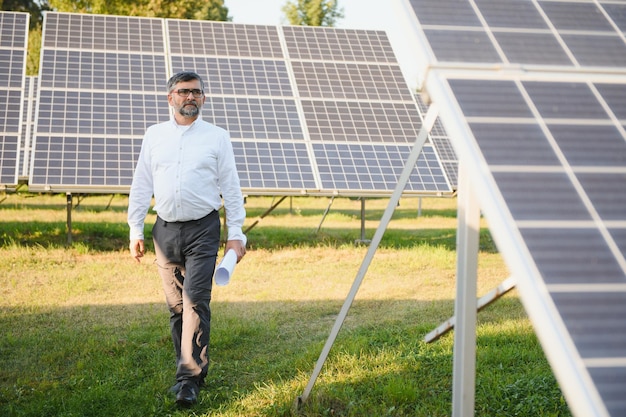 Architect standing by solar panels