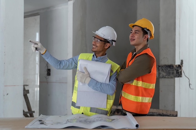 Architect watching some details in blueprint a construction site