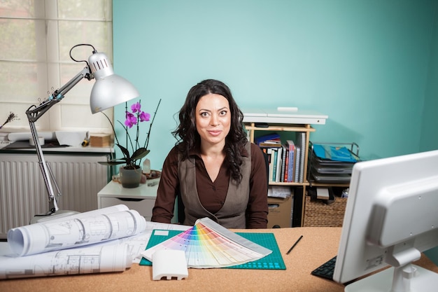 Architect with color palette on her desk. working on new architect and design plan. professional architecture blueprints