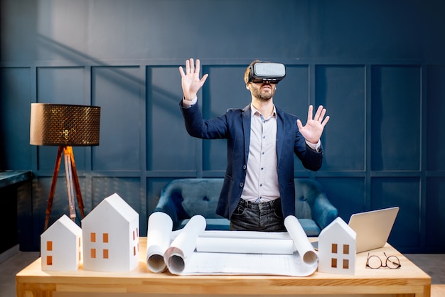 Architect with virtual glasses in the office