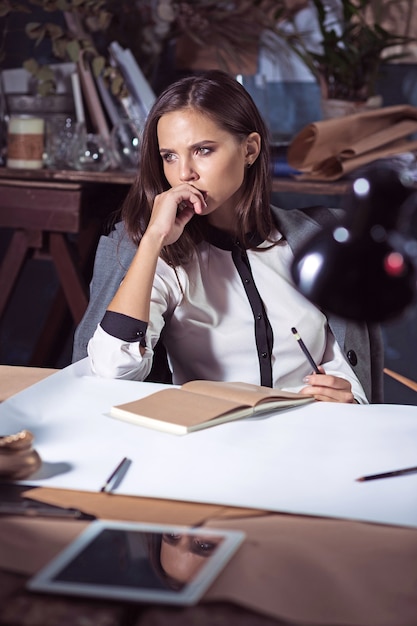 Architect woman working on drawing table in office or home.  shot