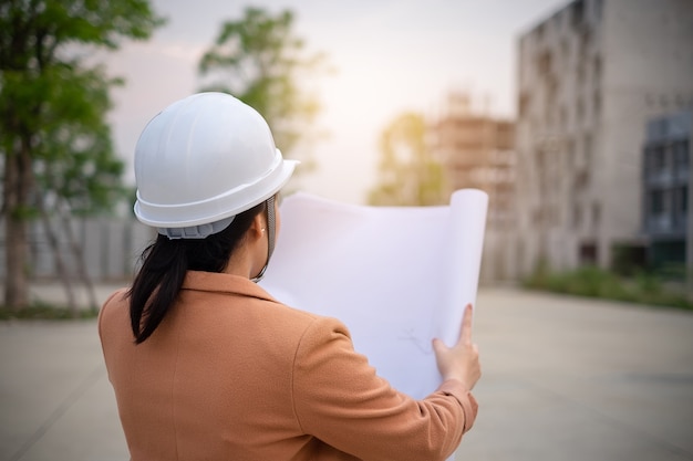 Architect woman working with blueprints for architectural 