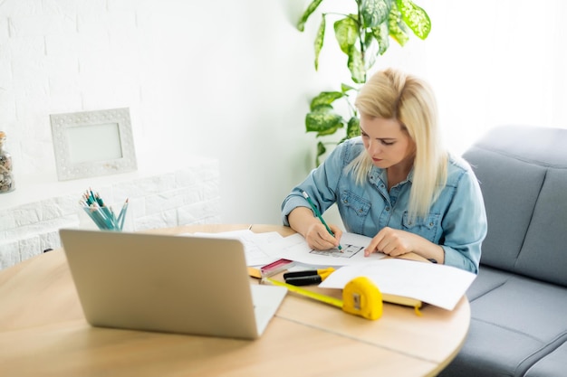 Architect working on blueprint. Architects workplace - architectural project, blueprints, ruler, calculator, laptop and divider compass. Construction concept. Engineering tools.