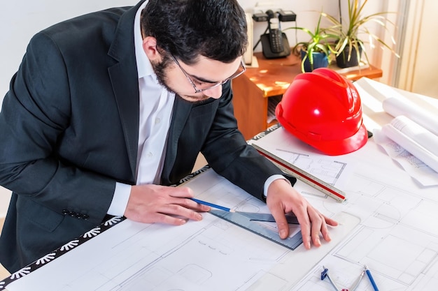 Architect working on blueprint in workplace