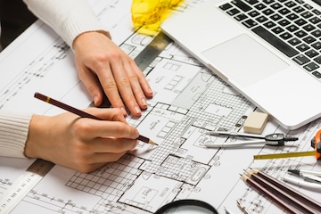 Architect working on blueprint | Premium Photo