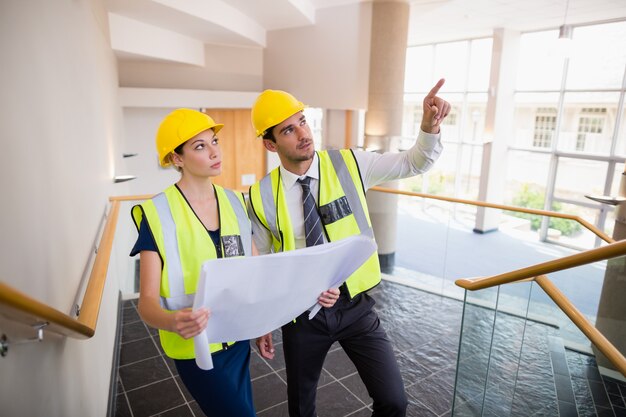 Architects discussing over blueprint