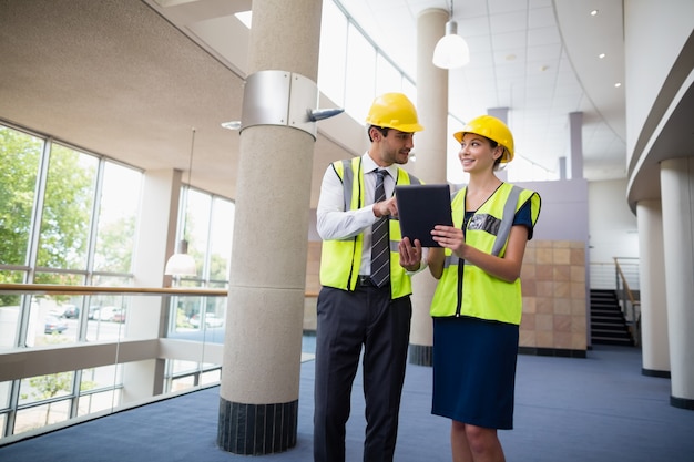 Architects discussing over digital tablet