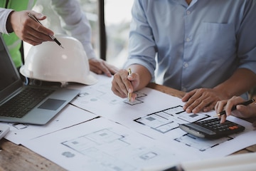 Architects and engineers are working together to edit the draft house plan that was designed after it was presented to the client and partially revised the design Interior design and decoration ideas | Premium Photo