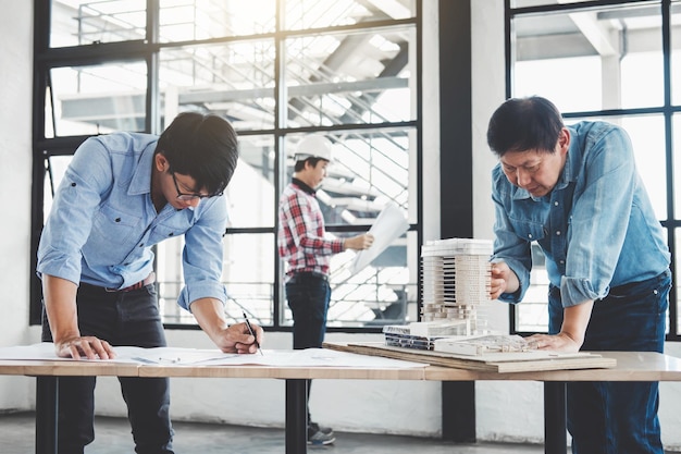 Architects making blueprint while working in office