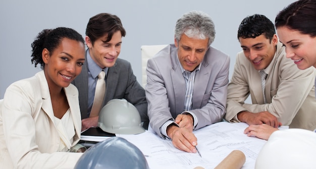 Architects in a meeting studying plans