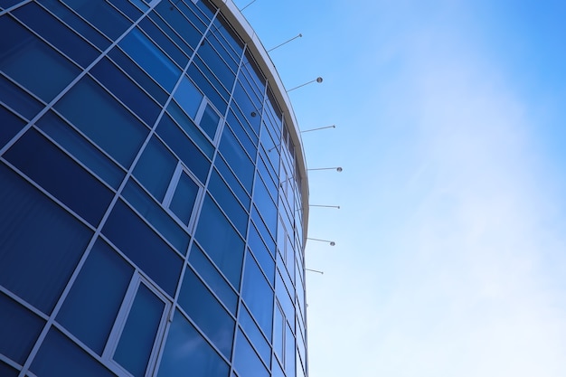 Architectural detail of the facade with multiple reflections of other buildings and the sun. Exterior of modern building. Architecture abstract background