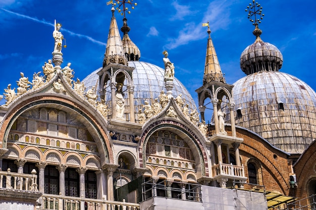 Architectural details from the upper part of facade of San Marco in Venice, Italy under blue sky