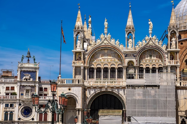 Architectural details from the upper part of facade of San Marco in Venice, Italy under blue sky