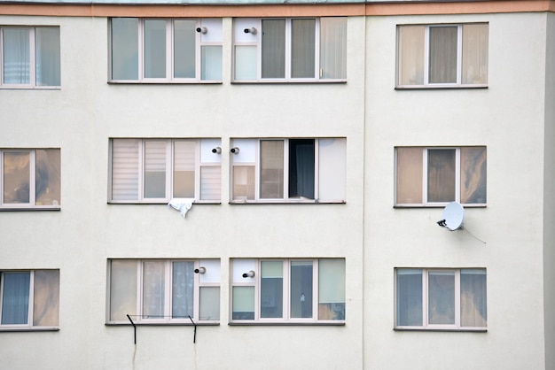 Architectural details of modern high apartment building facade with many windows and balconies