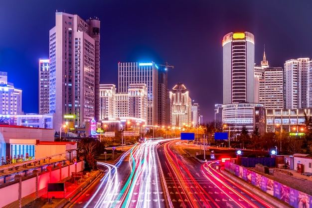 The architectural landscape of Qingdao city center and the light and shadow of car lights