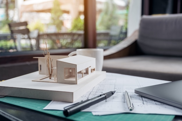 An architectural model and drawing paper