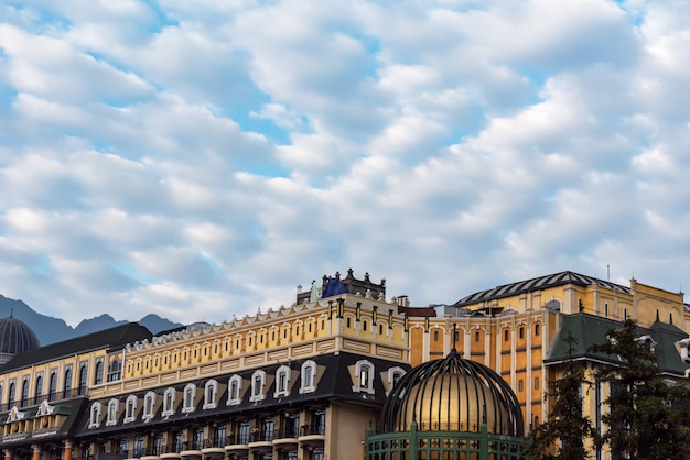 Architecture against blue sky and white clouds midday.