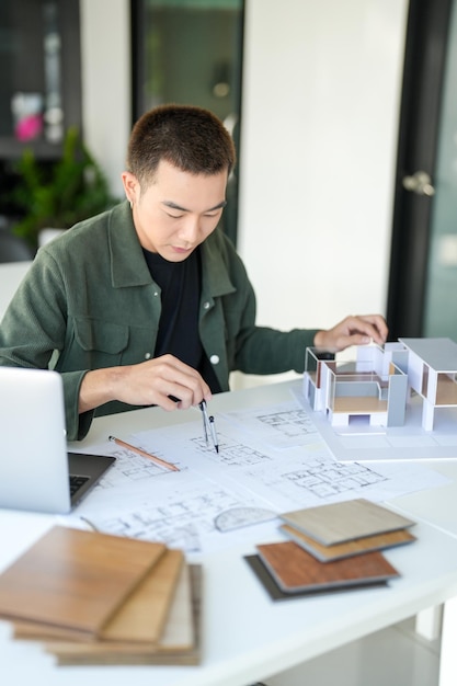 architecture man drawing on architectural creative project business architecture building construction industrial engineering achievement planning design on eco blueprint