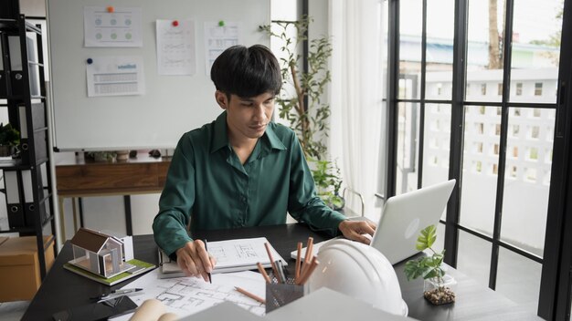 Architecture Man drawing on architectural Creative project business architecture building construction Industrial engineering Achievement Planning Design on eco blueprint
