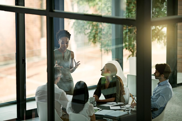 Are you getting the idea High angle shot of a young businesswoman giving a presentation in the boardroom