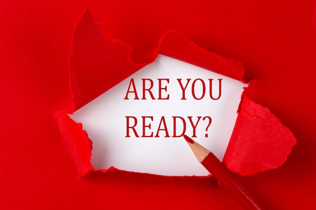 ARE YOU READY text on the red torn paper with red pencil