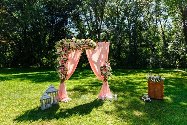 Area of the wedding ceremony in the park Wooden rectangular arch rustic decor