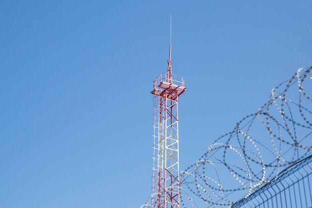 Area with barbed wire. Dangerous area. Private territory. Energy tower