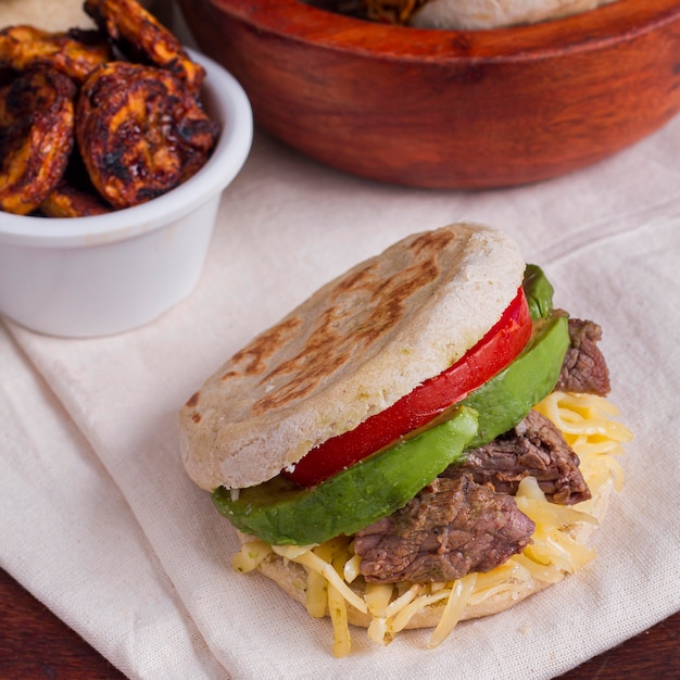 Arepa with tomato and meat