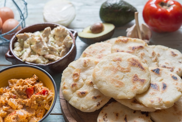 Photo arepas with reina pepiada and egg revueltos