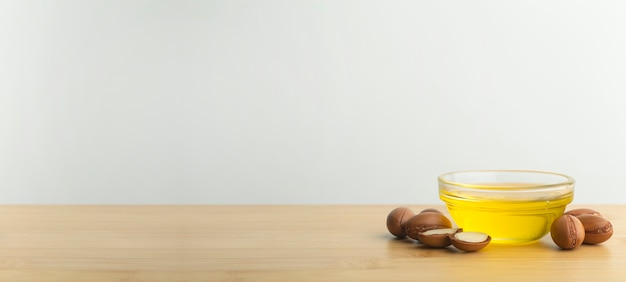 Argan nuts and oil on a wooden table