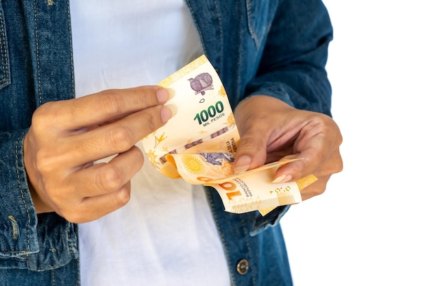 Argentine woman counting Argentine peso bills