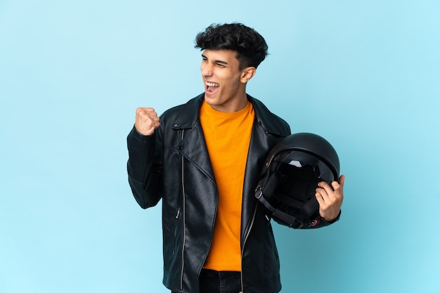 Argentinian man with a motorcycle helmet celebrating a victory