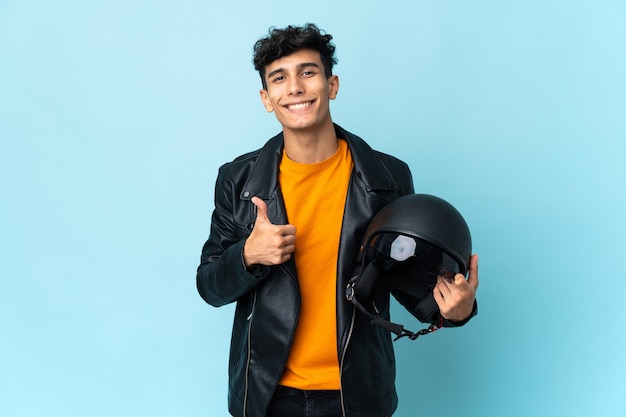 Argentinian man with a motorcycle helmet giving a thumbs up gesture